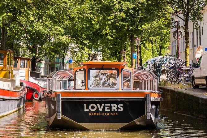 Amsterdam 1h Canal Cruise by Semi-Open Boat with Audio Guide - Your route, stop by stop: canals, merchant houses, and big landmarks