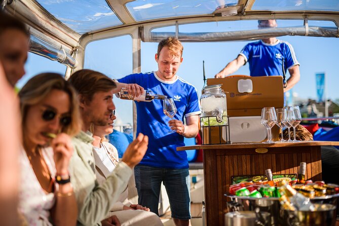 Amsterdam: Canal Booze Cruise with Unlimited Drinks Option - Amstel River sights: Skinny Bridge and the 7 Bridges canal