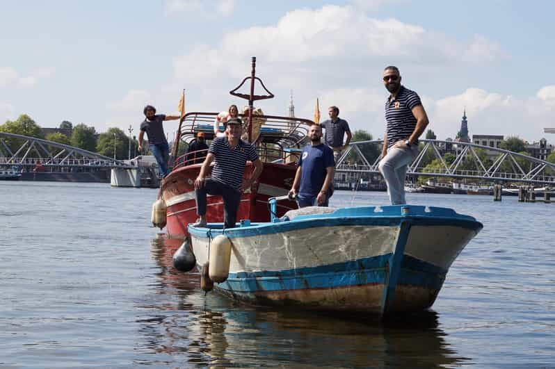 Amsterdam: Canal Cruise on a Wooden Refugee Boat - The captain-guides: stories, not scripts