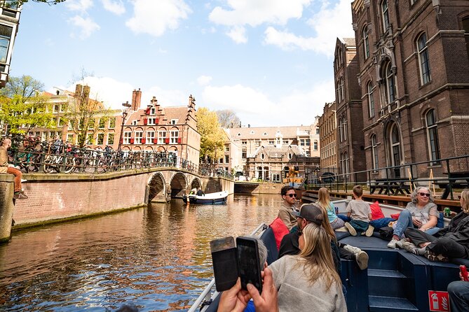 Amsterdam Canal Cruise with Live Guide and Two Drinks - Seeing Anne Frank House from the water without losing the meaning