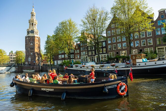Amsterdam: Guided Open Boat Canal Cruise Unlimited Drinks Option - Open-boat canal cruise: what you’re buying for $23.59