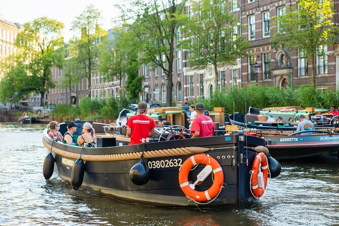 Amsterdam: Guided Open Boat Canal Cruise Unlimited Drinks Option - NEMO and the maritime museum: science and sea power from the canal deck