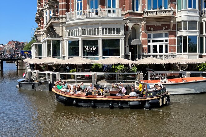 Amsterdam Luxury Boutique Boat tour with Unlimited Beer and Wine - Oude Kerk and the oldest parish church feel: old stone, modern events