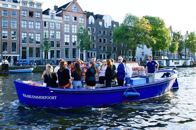 Amsterdam Open Boat Sightseeing Canal Cruise - Open-air comfort: rain gear and seat reality