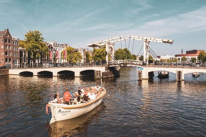 Amsterdam Private Boat Trip with Pizza and Unlimited Drinks - A green ship-like science museum and the city’s bridges-as-scenery
