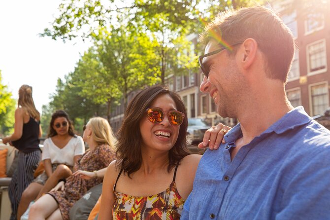 Amsterdam Private Boat Trip with Pizza and Unlimited Drinks - Rembrandt van Rijn square, Red Light District architecture, and Amsterdam’s main station