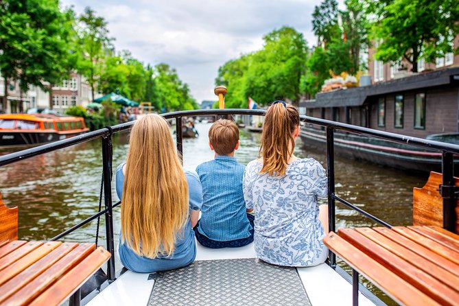 Amsterdam Small-Group Canal Cruise With Dutch Snacks and Drink - Amstel River, a famous bridge, and the city’s pulse