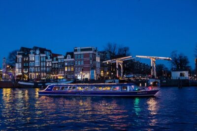 Evening Canal Cruise in Amsterdam with Wine & Cheese Option - Westerkerk and Amsterdam Centraal: big architecture, best seen from the water